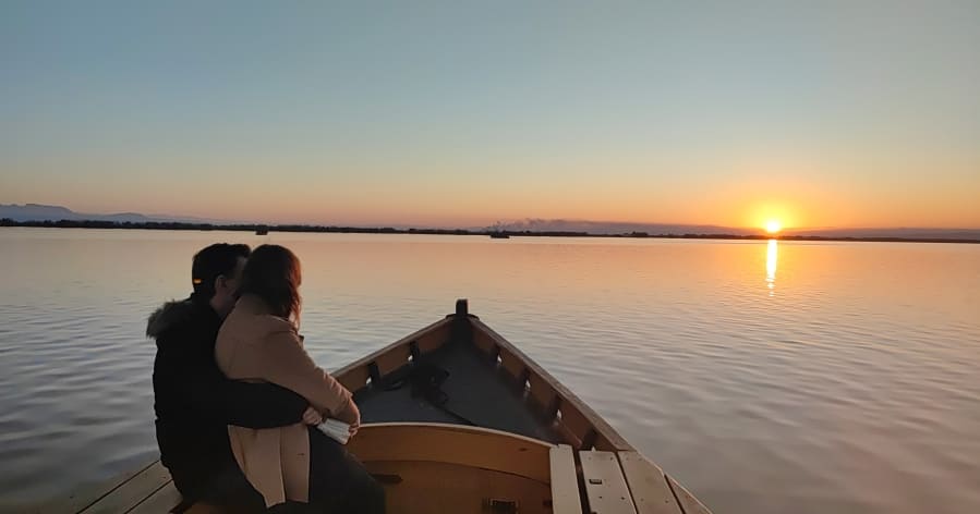 Pareja viendo el atardecer desde una barca en la Albufera de Valencia